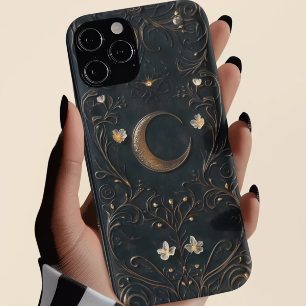 Close-up of a hand holding the Dark Celestial phone case, featuring a golden crescent moon and floral vine design with a vintage grimoire aesthetic.
